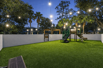A park with a bench and a playground.